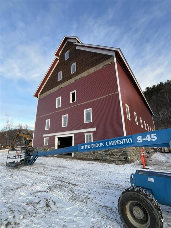 The East Monitor Barn with new red siding during restoration