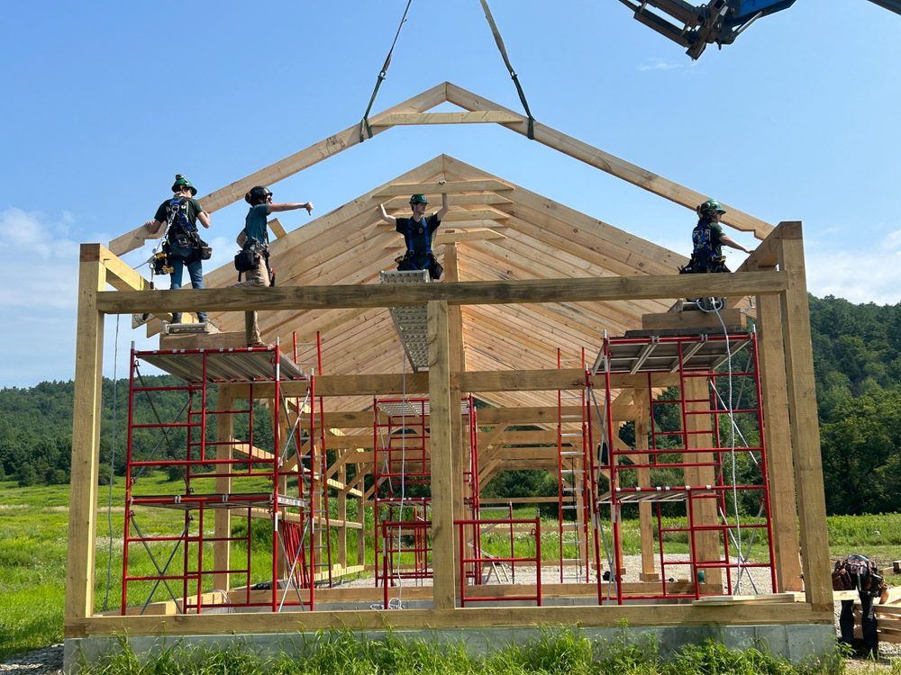 VYCC Corps Members raising a timber frame structure on campus